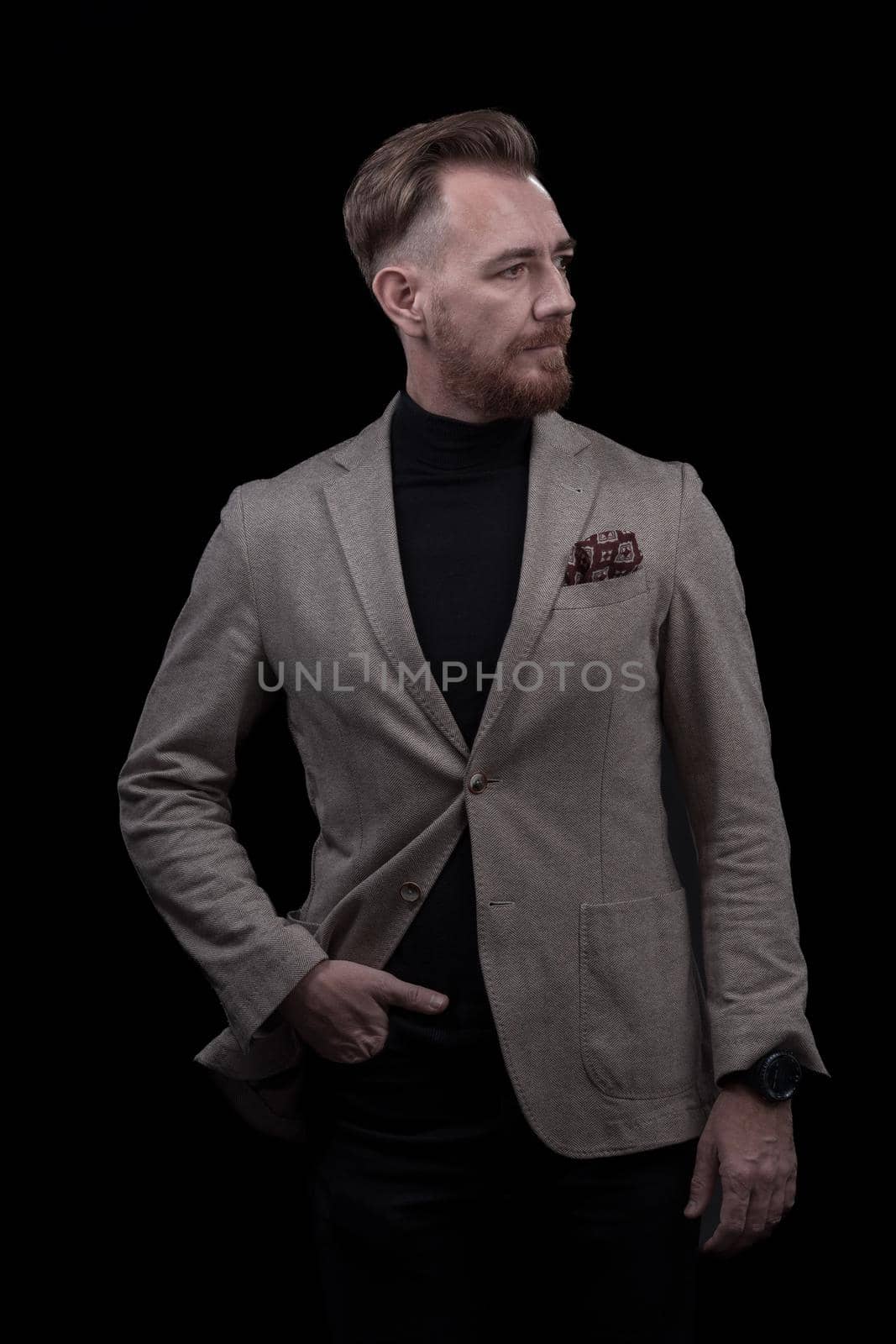 Portrait of a stylish elegant senior businessman with a beard and casual business clothes in photo studio isolated on dark background gesturing with hands by dotshock