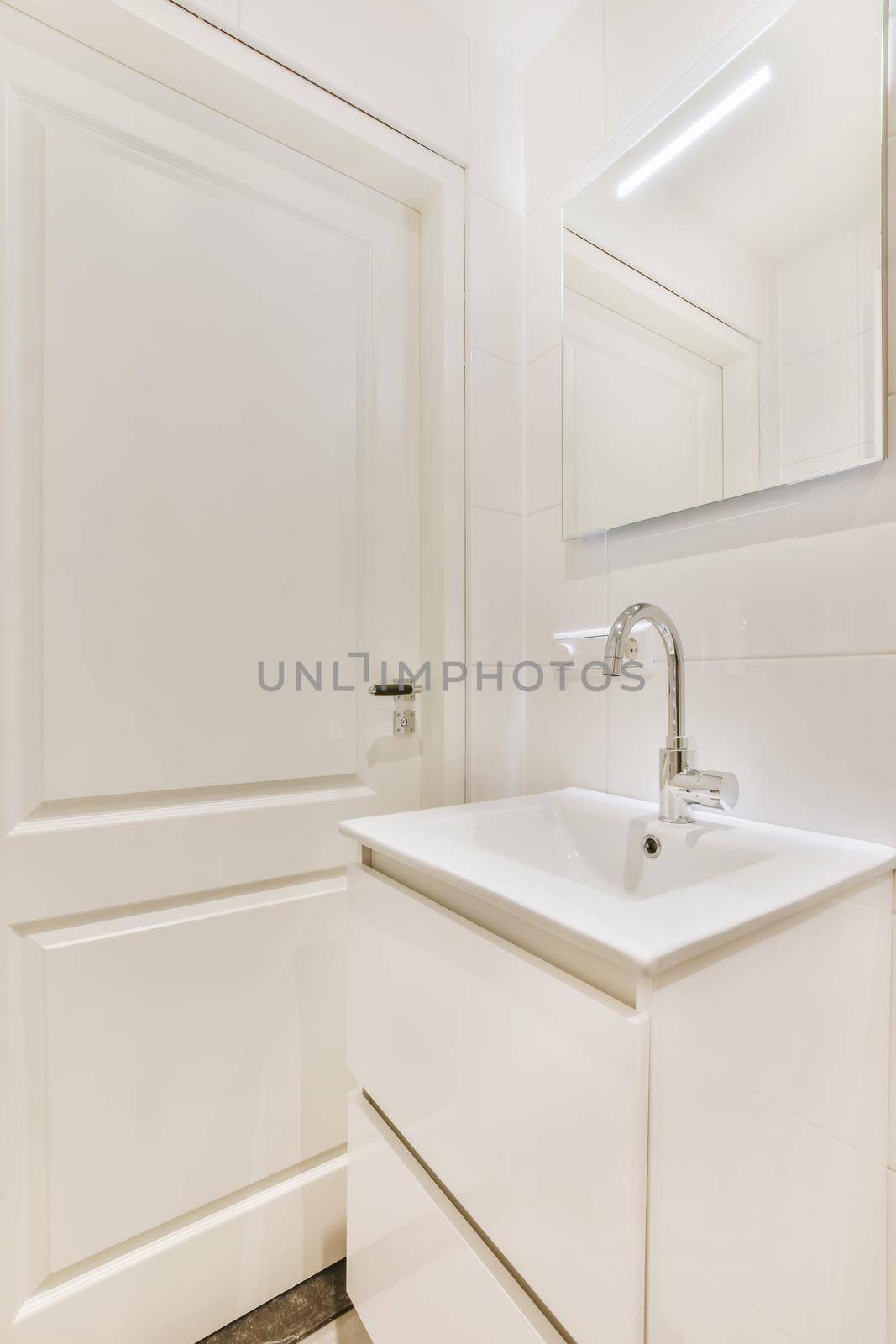 An all-white bathroom in an elegant apartment