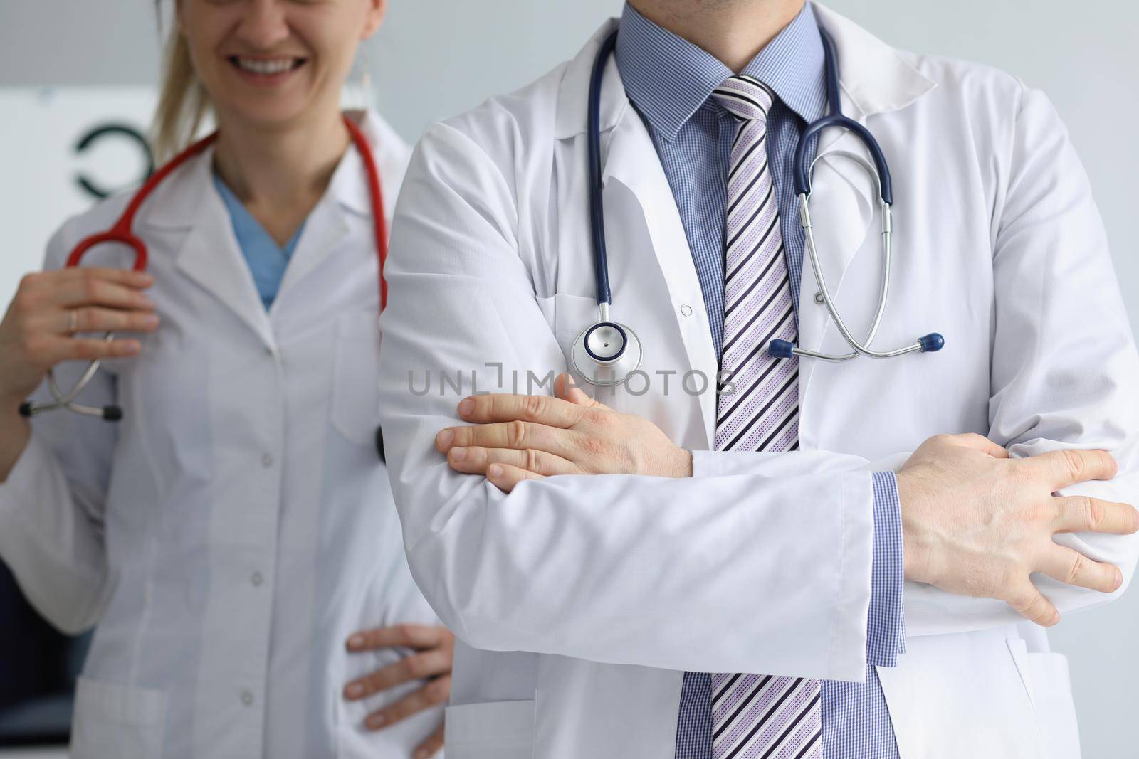Close-up of medical workers in uniform with stethoscopes, medical help, emergency team, qualified doctor and nurse. Medicine, healthcare, checkup concept