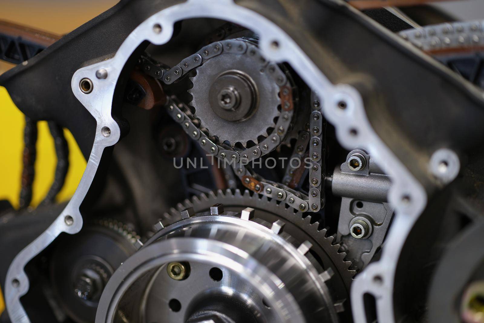 Close-up of motorbike construction system with metal chain and others details. Brand new bike or just after maintenance in service centre. Vehicle concept