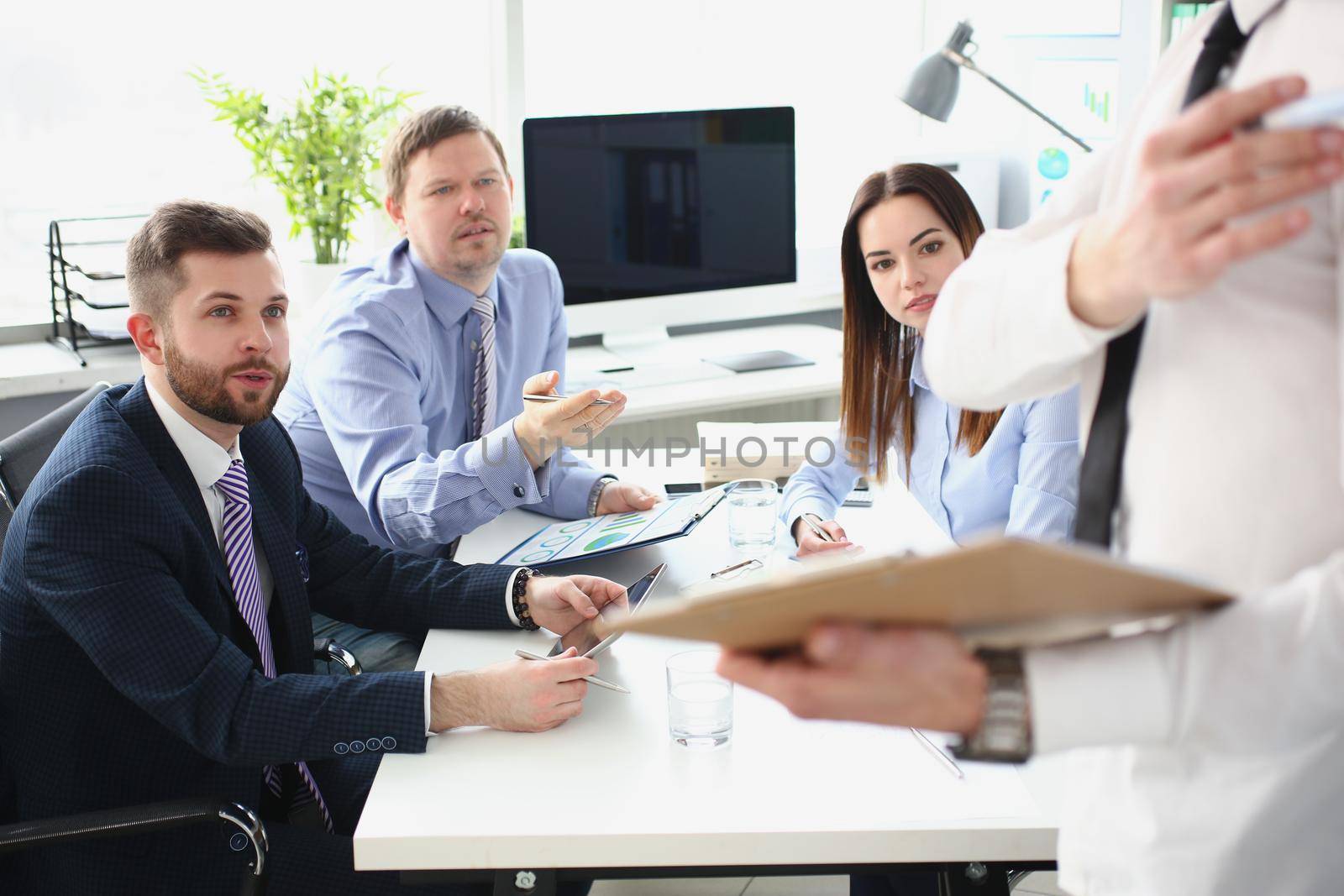 Portrait of smart man making presentation for colleagues, manager showing finance statistics to team. Company and business meeting, development concept