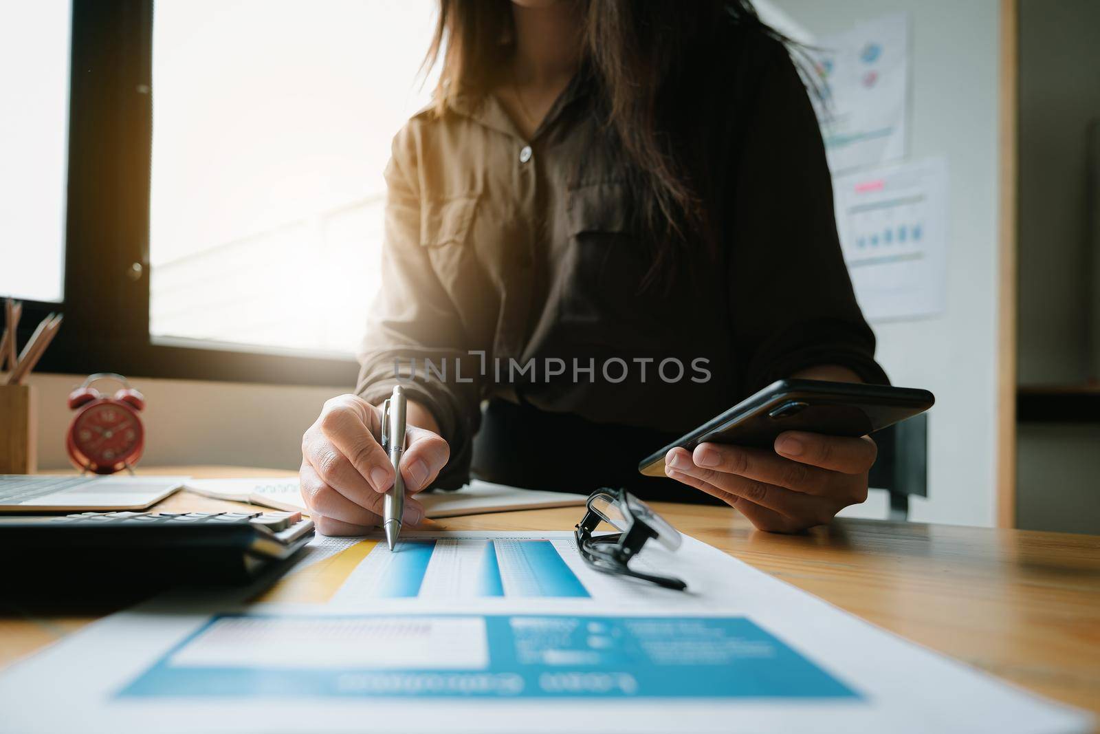 Close up Business woman hand holding pen and financial paperwork with financial network diagram. vintage concept.