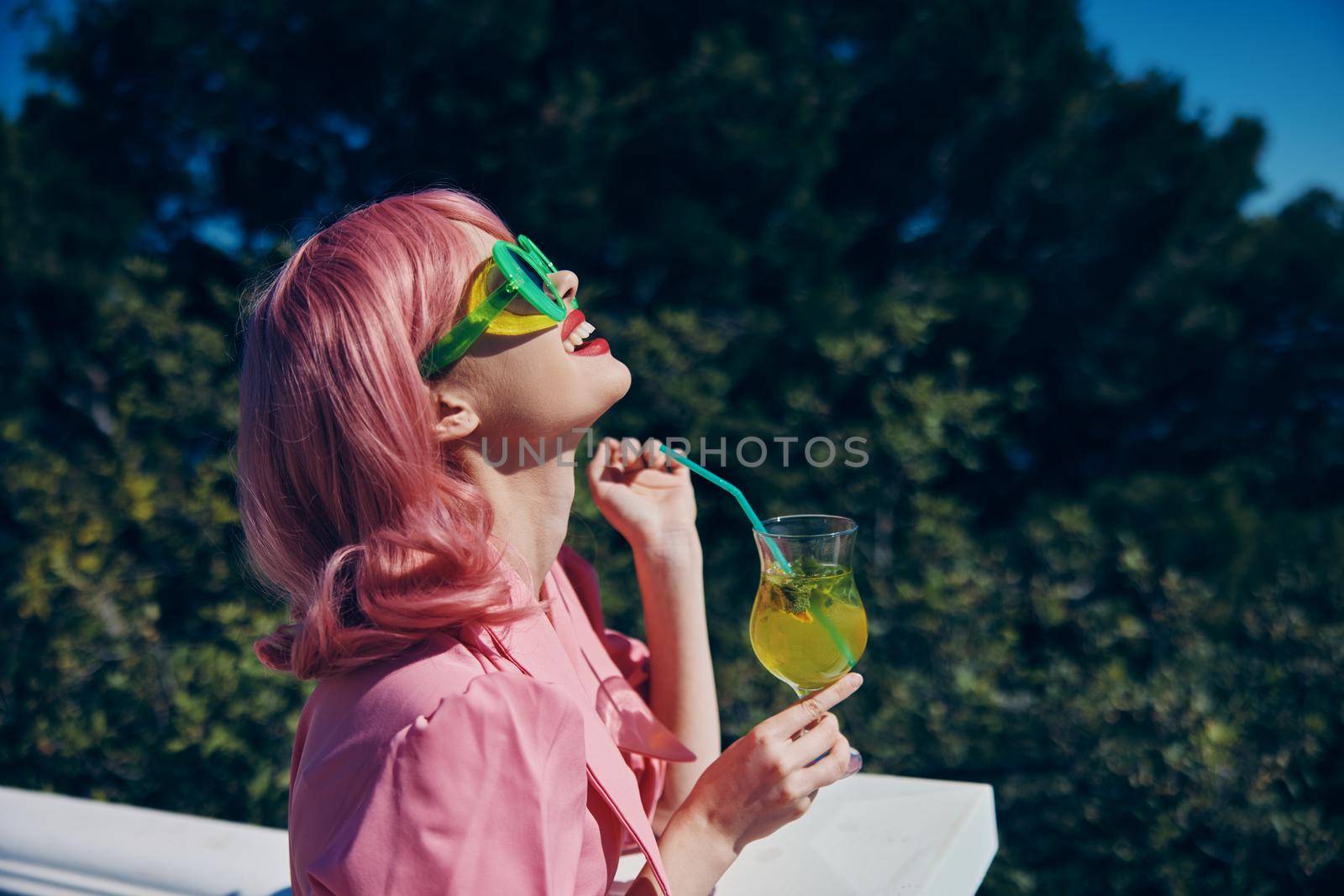 portrait of beautiful woman enjoying a colorful cocktail hotel terrace Happy female relaxing. High quality photo