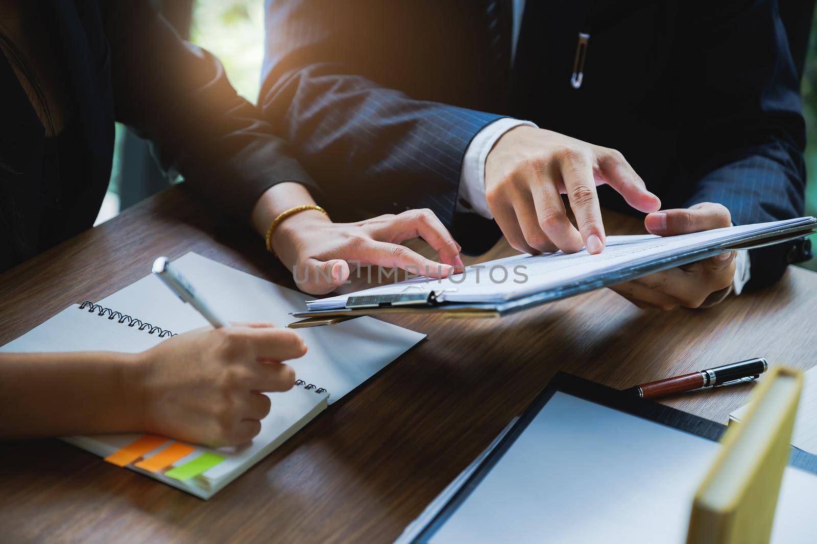 Fund managers team consultation and discuss about analysis Investment stock market by document sheet.