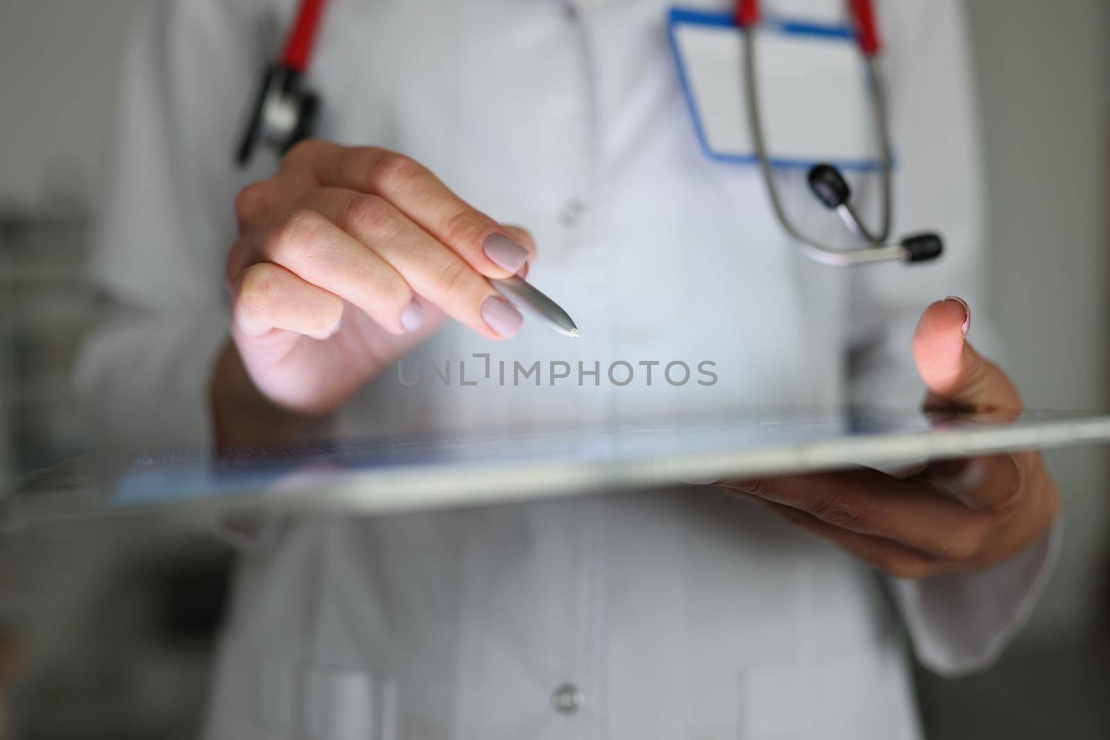 Close-up of doctor using tablet to correct patient history, modern device help in clinic work. Manage appointment, online consultation. Development concept