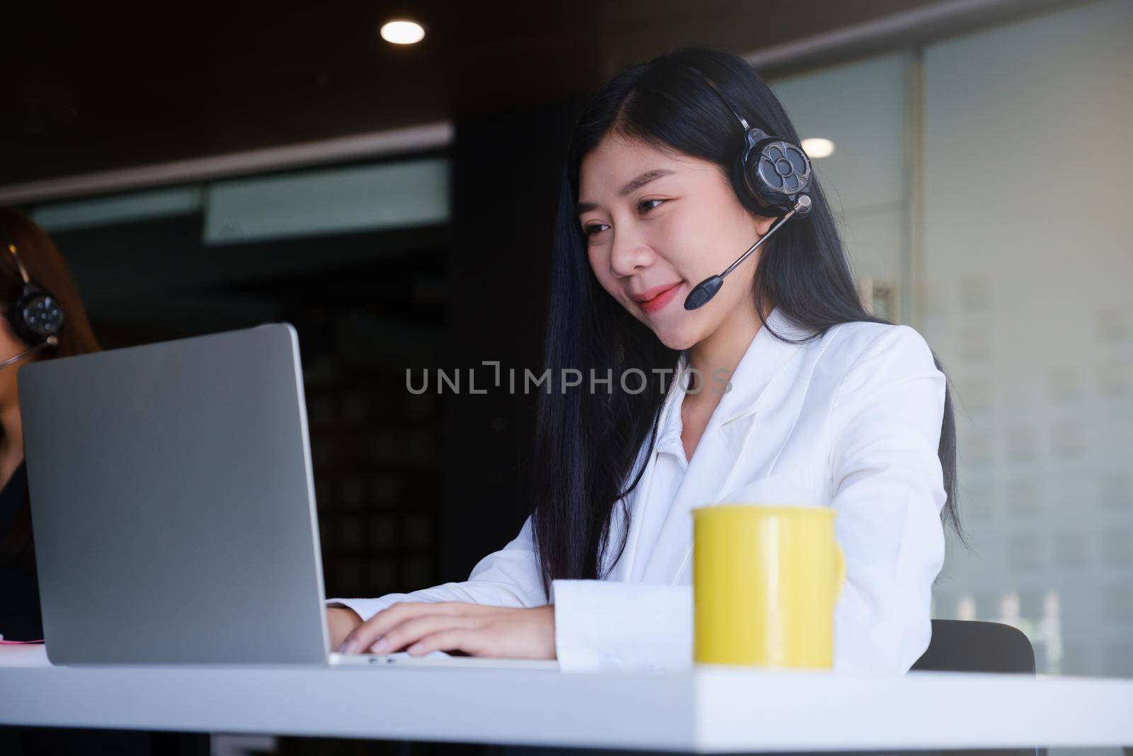 Beautiful business woman or call center workers in headphones for communication and consulting people. Support concept.