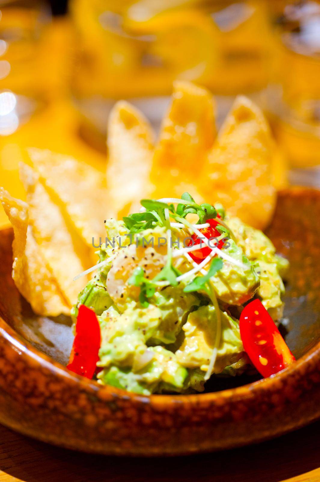 fresh avocado and shrimps salad with nachos on side