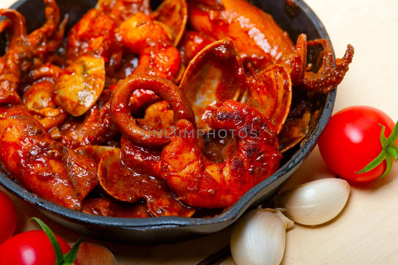 fresh seafoos stew on an iron skillet by keko64