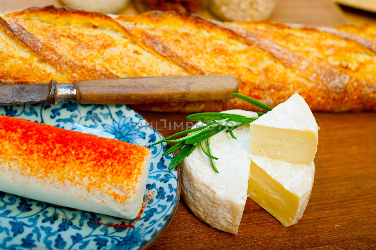 French cheese and fresh  baguette on a wood cutter