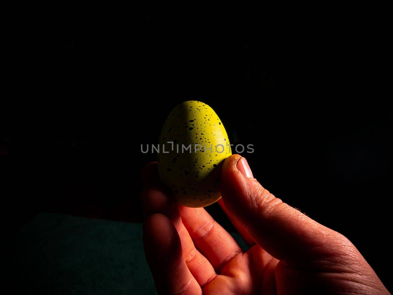 Easter chicken eggs in hand on a black background. Easter chicken eggs. Christ is risen. Christian religion. Religious holiday. Palms of human hands. Christian culture. Religious prayer. Tradition.