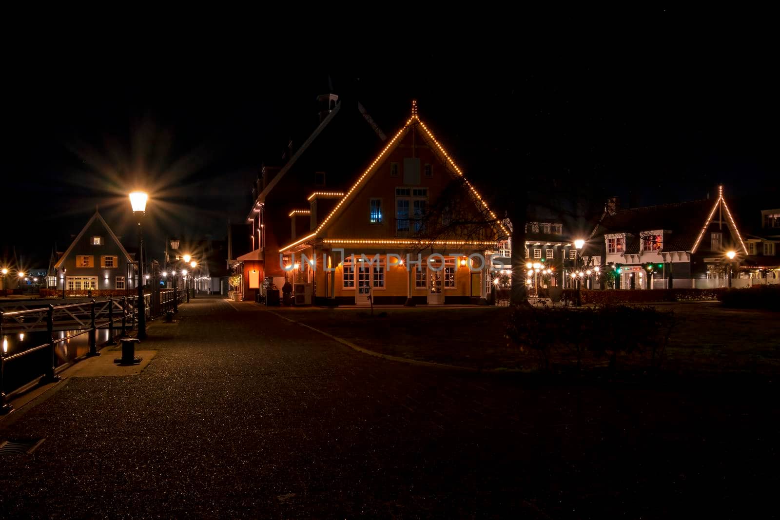 Old traditional dutch wooden houses in Friesland the Netherlands by night in christmas time