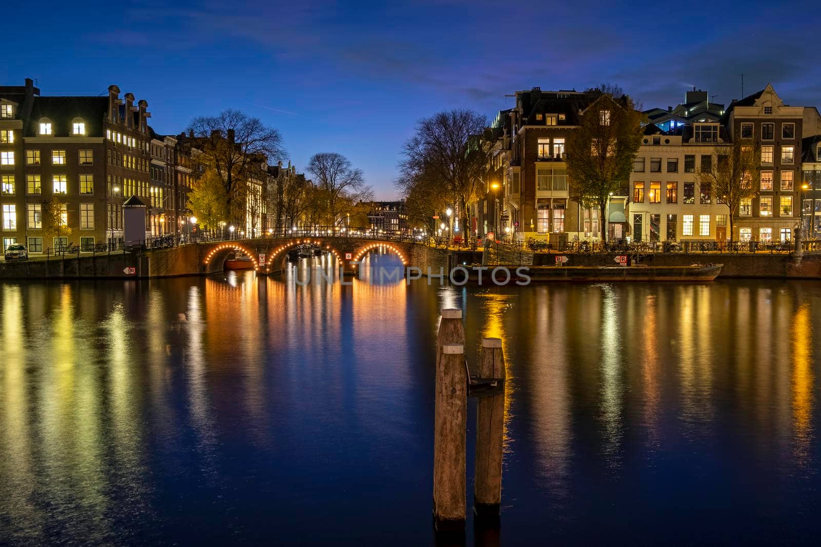 City scenic from Amsterdam at the river Amstel in the Netherlands at sunset by devy