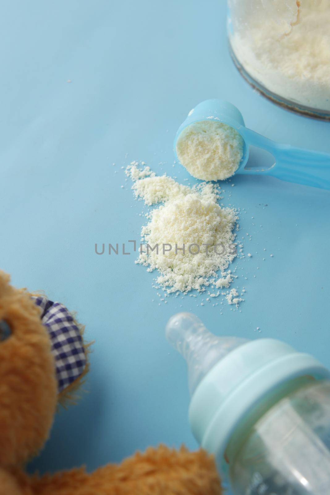 Close up of baby milk powder and spoon on tile background. by towfiq007