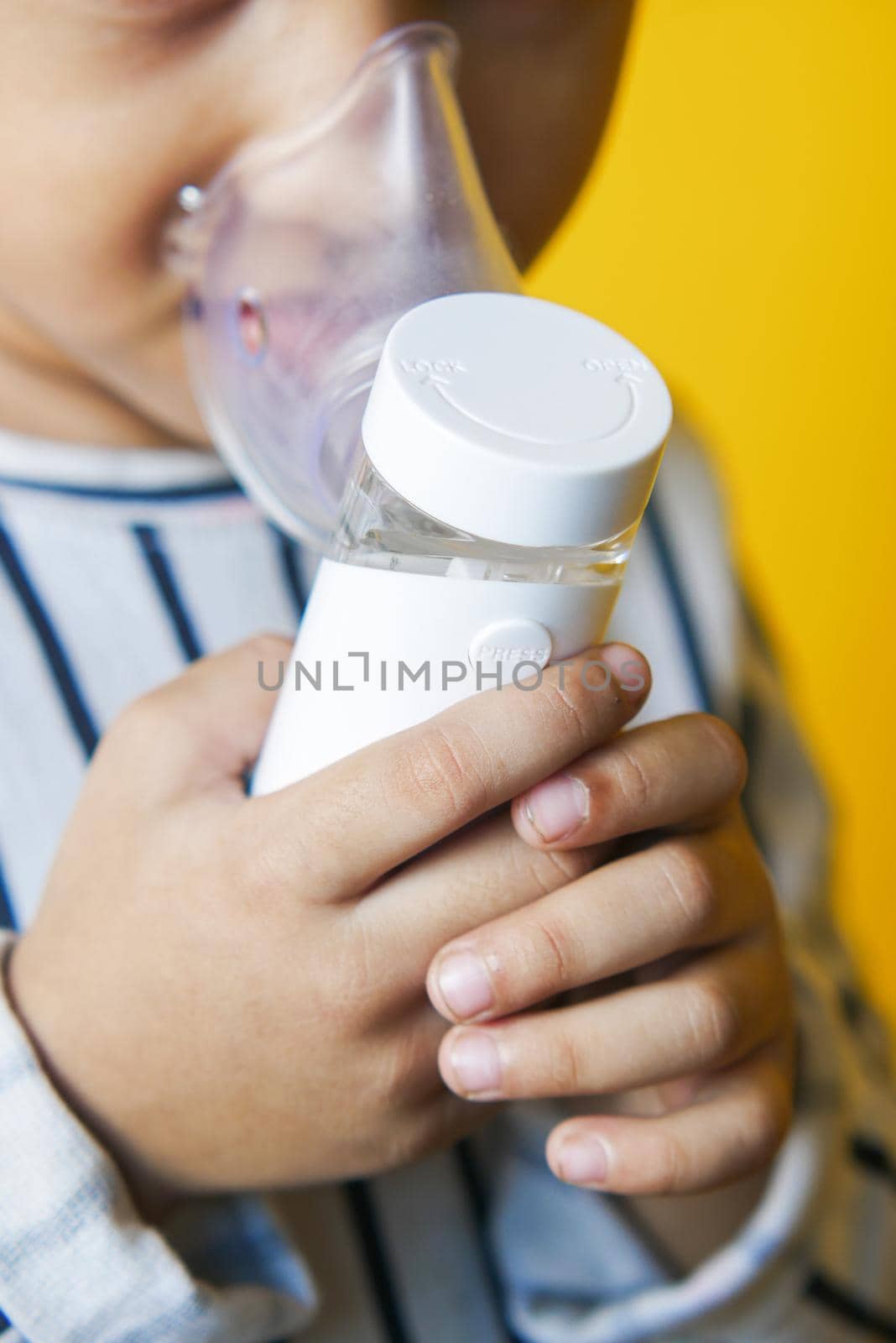 child girl using a nebulizer close up by towfiq007