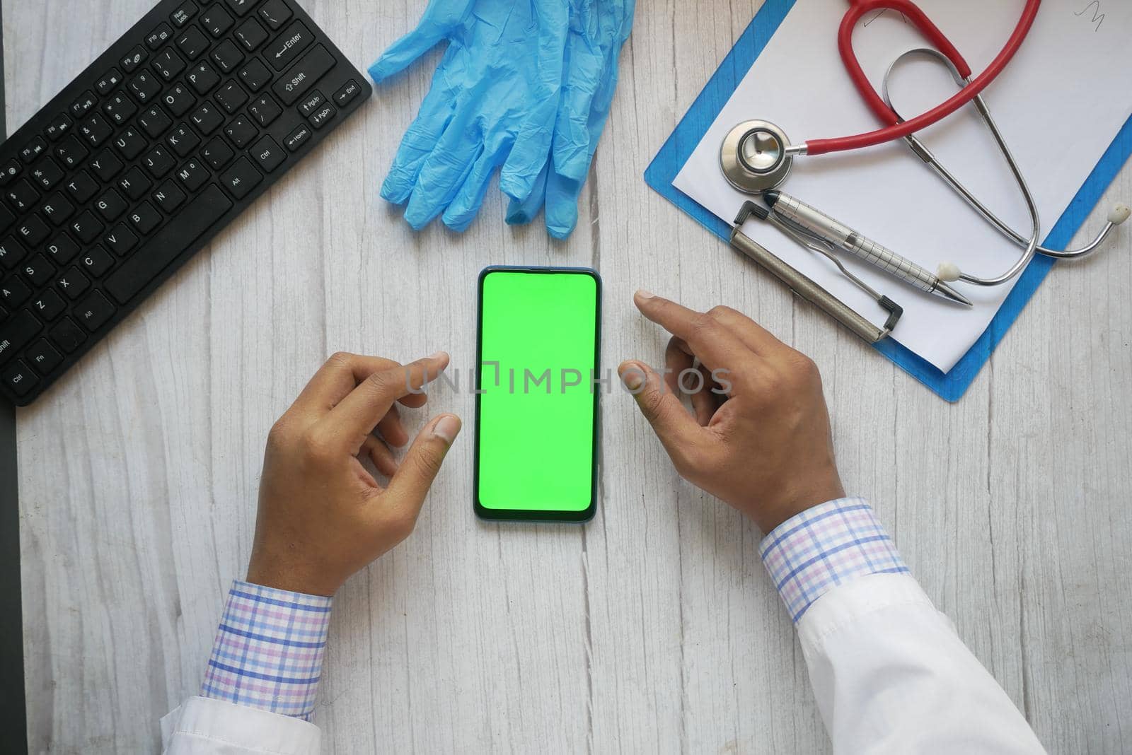 doctor in white coat using a smartphone