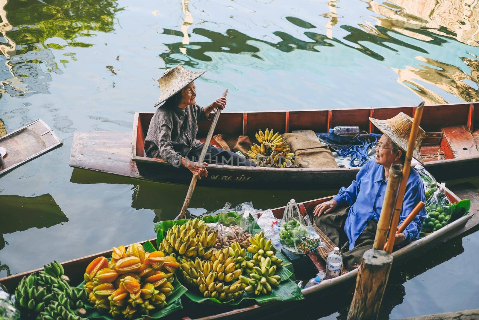 people sale fruit on boat at Damnoen Saduak Floating Market in Thailand.,27 November 2020.,THAILAND.