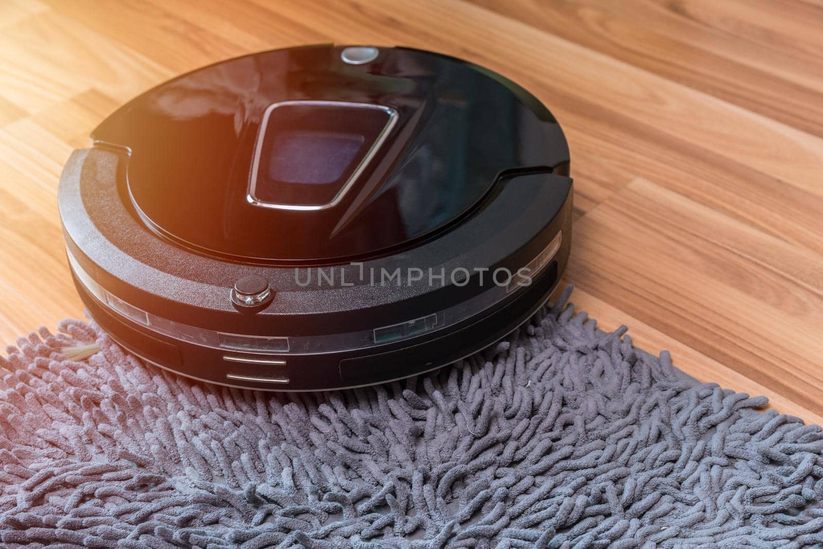 robot vacuum cleaning the floor with doormat automatic home cleaning machine
