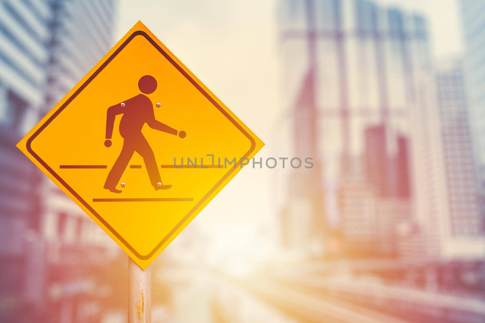 Traffic crosswalk sign on blur modern city office building background. Business people walking forward concept.