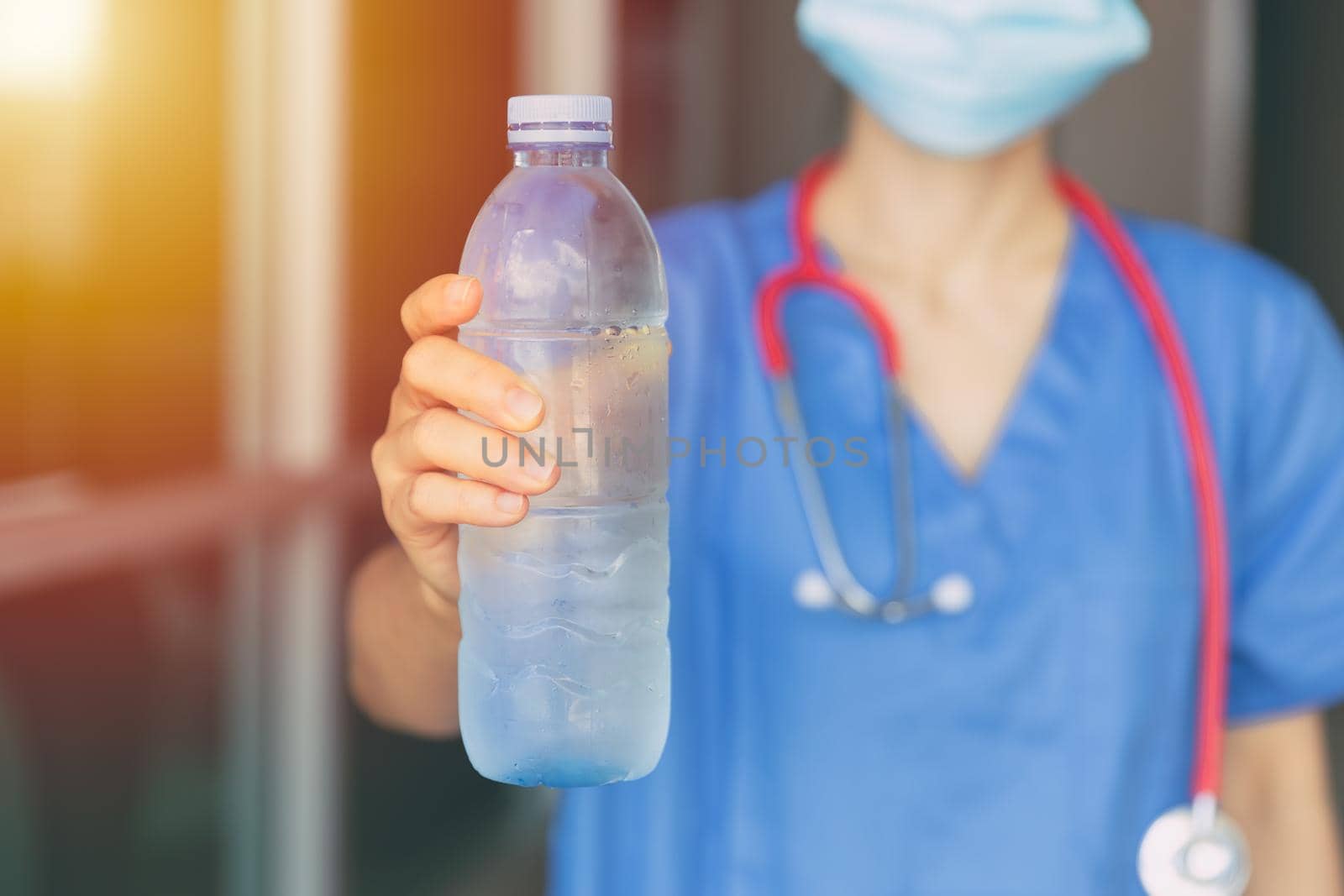 Doctor Nurse giving or recommend drinking clean cool water in hot summer for prevent dehydration.