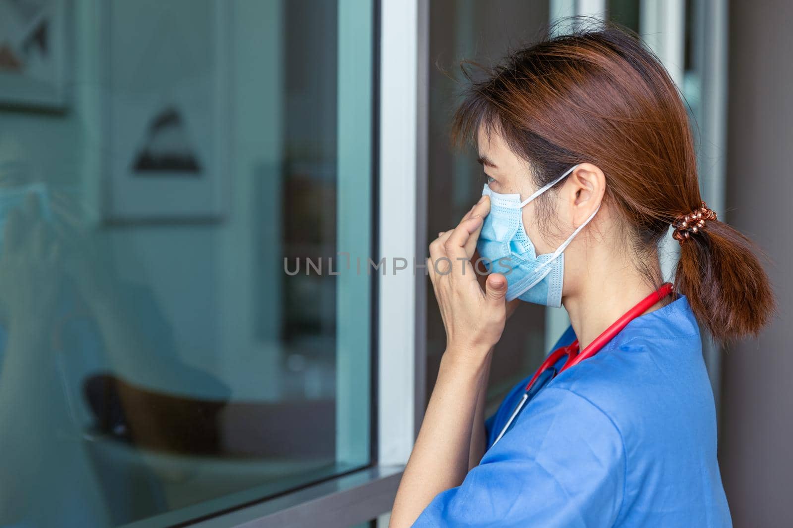 Nurse Doctor medical staff check tightness fit air leak seal of wearing the mask for safety Covid protection