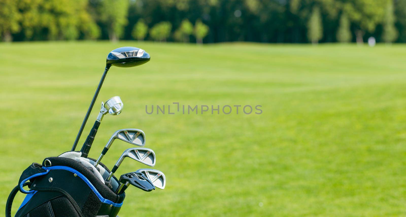 Golf clubs in a golf bag isolated. Set of golf clubs for a golfer. Copy Space. green Background. Close-up. High quality photo