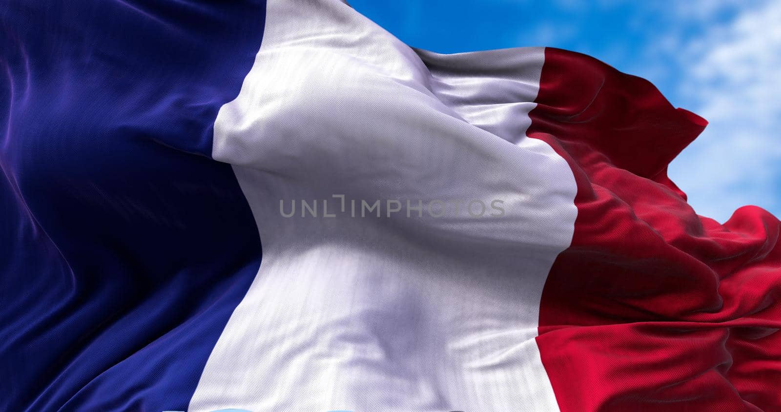 Detail of the national flag of France flying in the wind. Democracy and politics. European country.