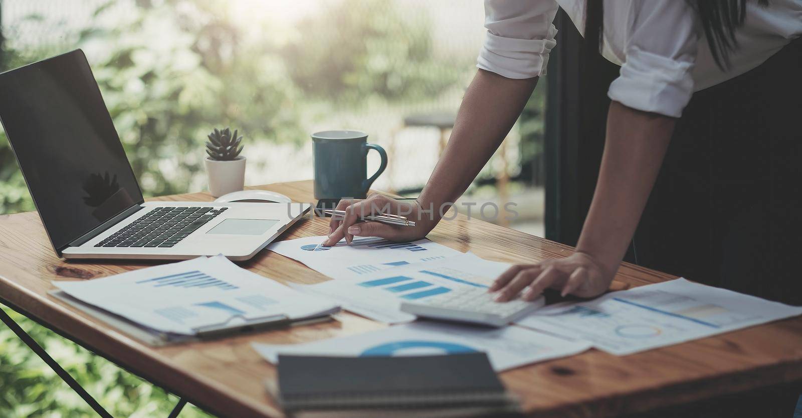 Businesswomen analyzing investment graph and discussing plan in meeting room, investment concept by wichayada