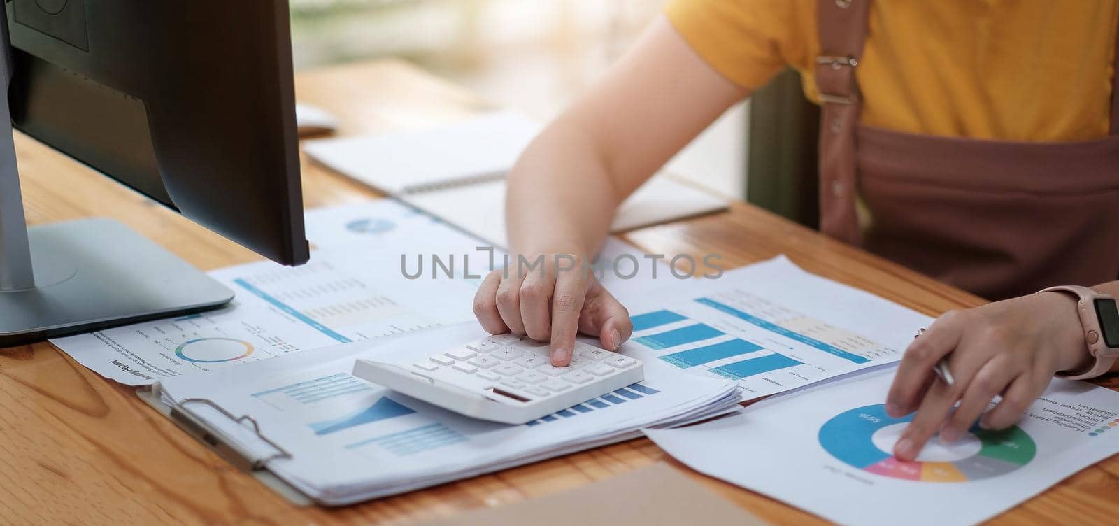Close up woman investment consultant analysis company annual financial report balance sheet statement working with documents graphs.