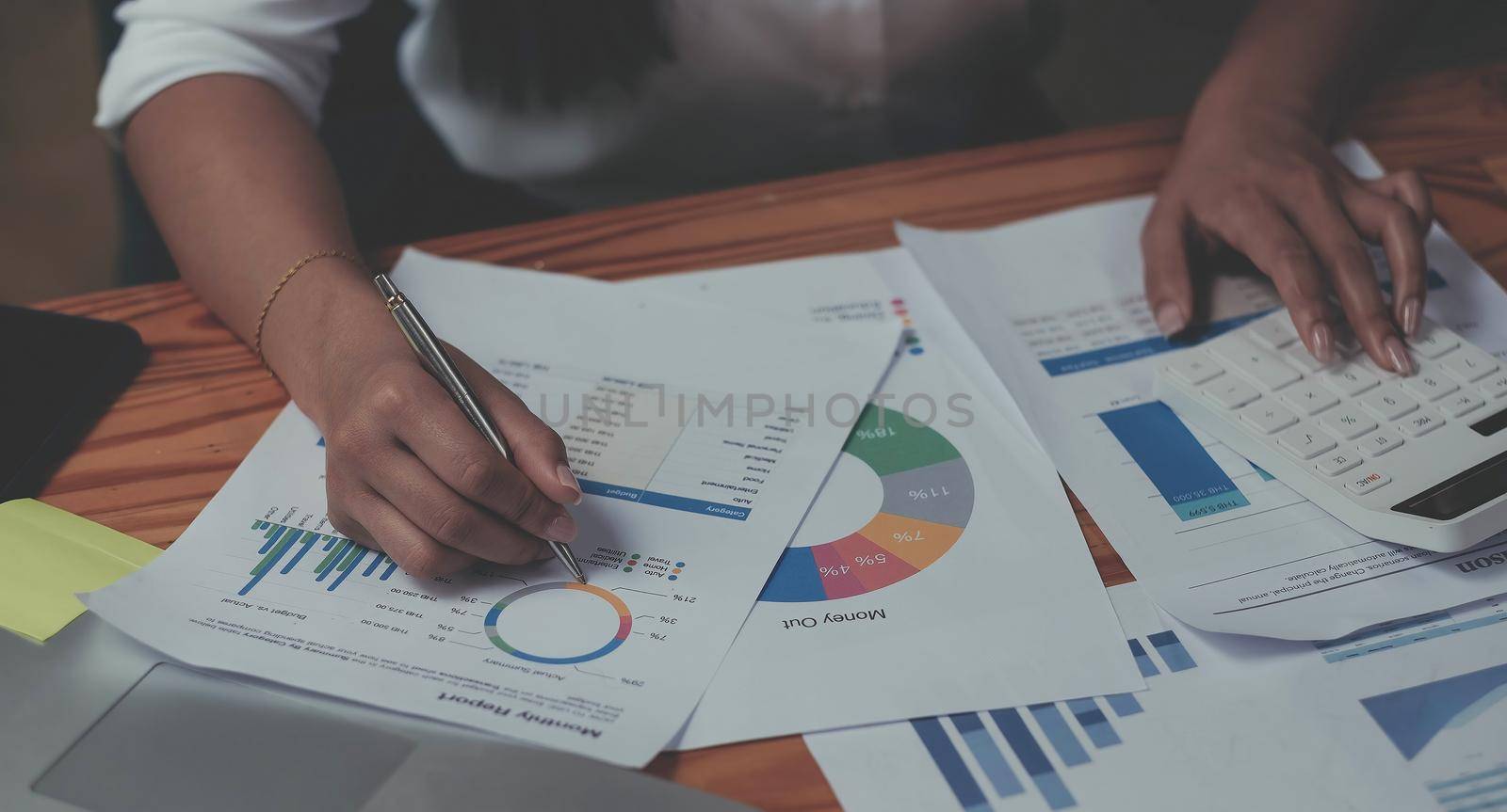 Business woman using calculator for do math finance on wooden desk in office and business working background, tax, accounting, statistics and analytic research concept.