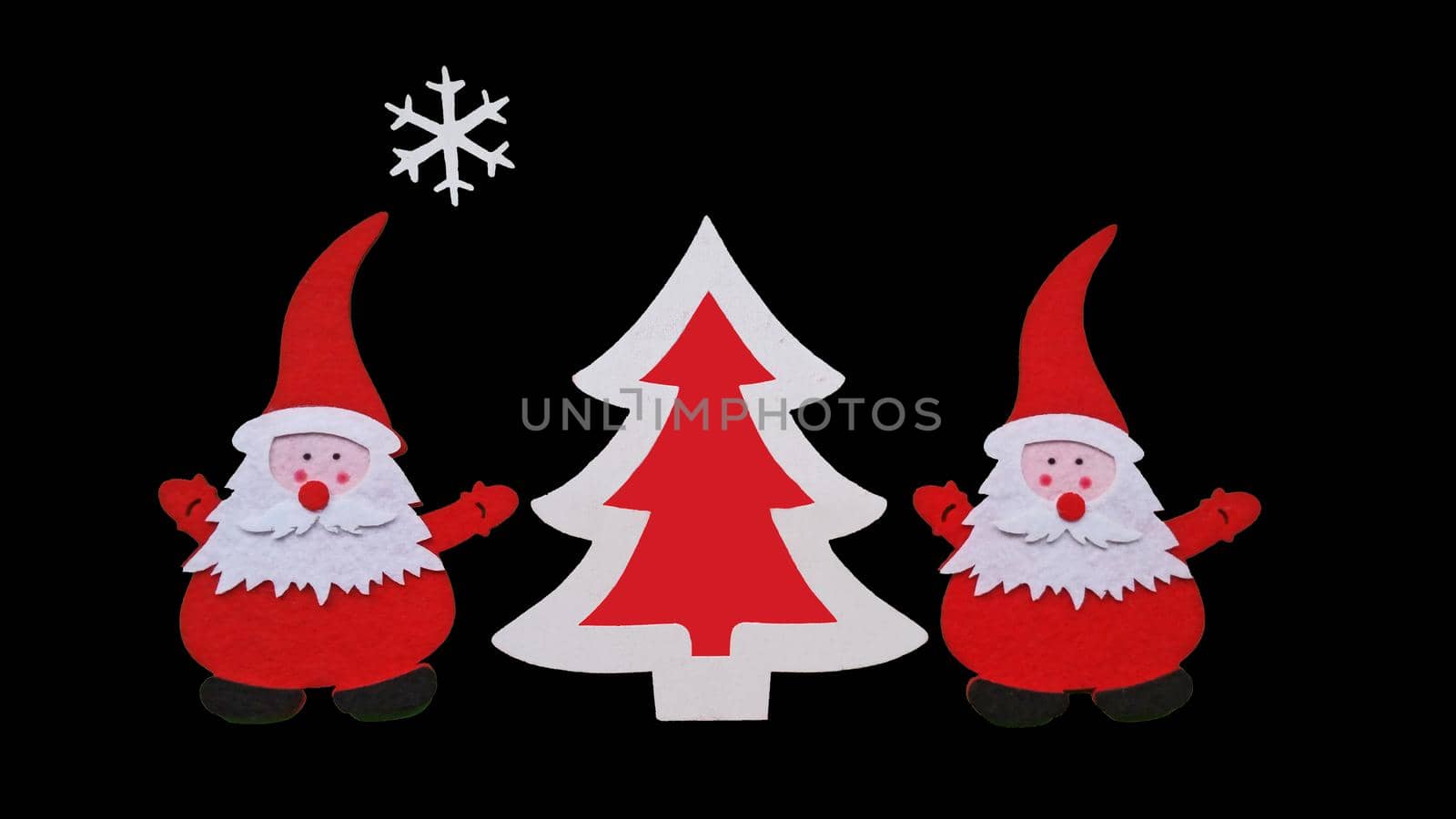 Drawing of Santa Claus and Christmass tree made of glued pieces of felt and plywood on a black background, hand-made