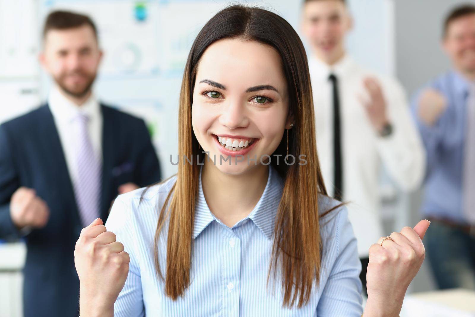 Portrait of woman leader present her team, male workers posing on background. Businesswoman proud of colleagues, employees follow boss. Teamwork concept