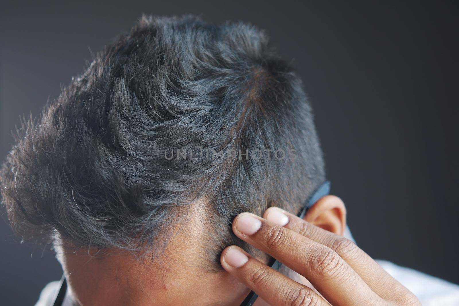 hair loss concept with man checking his hair .