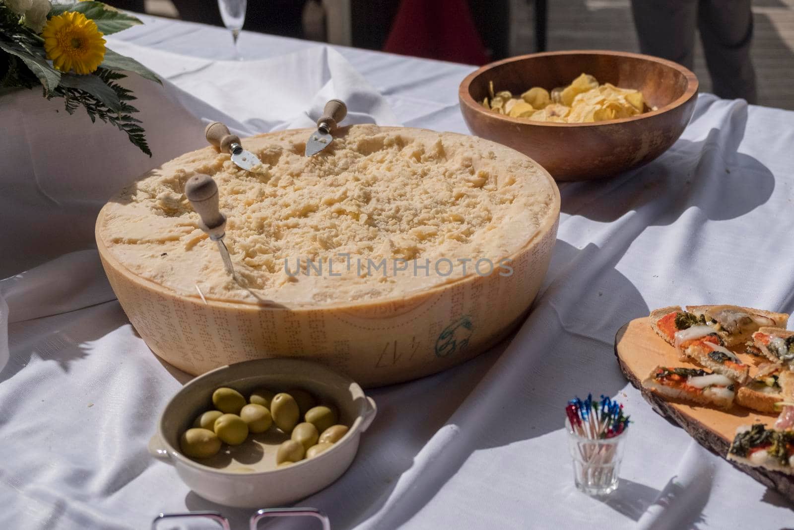 half wheel parmigiano reggiano with cutting knives at wedding reception. High quality photo