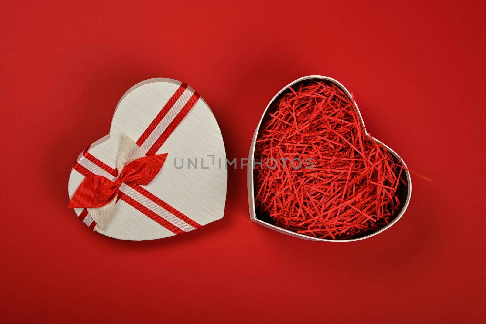 Open heart shaped gift box over red by BreakingTheWalls