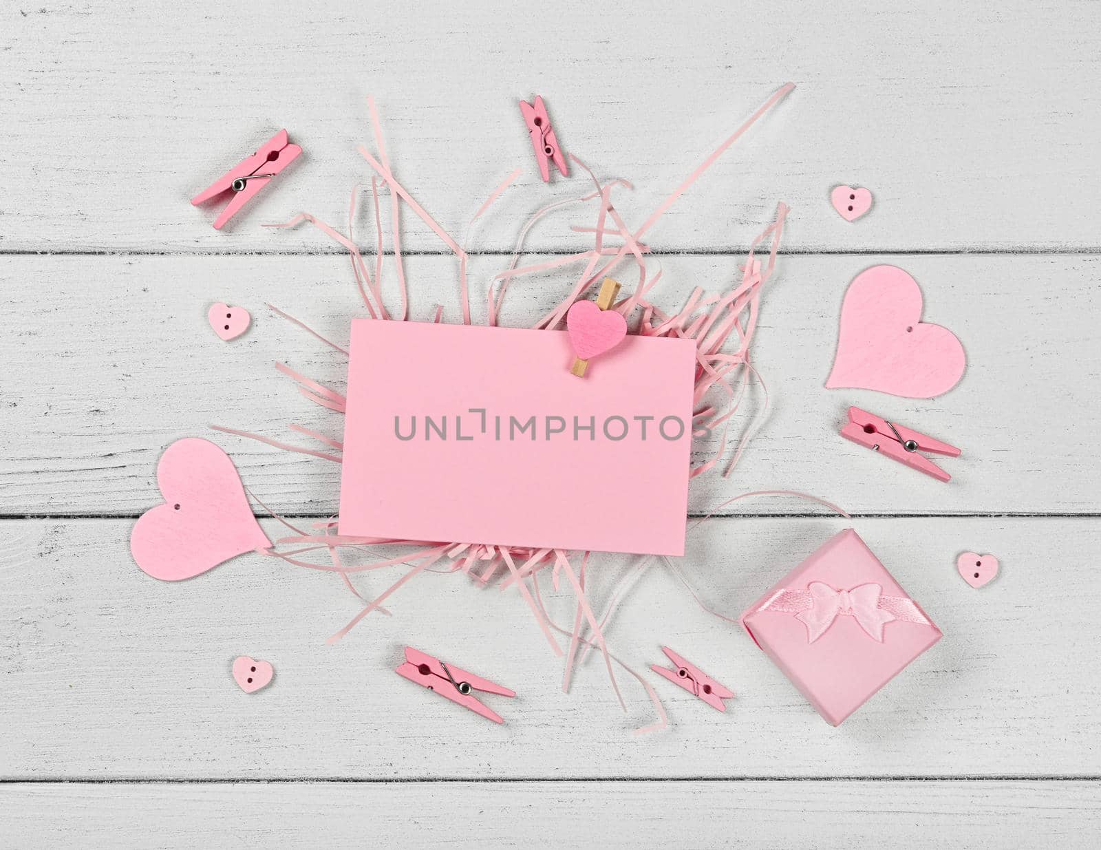 Pink Valentine paper card note on white wood by BreakingTheWalls