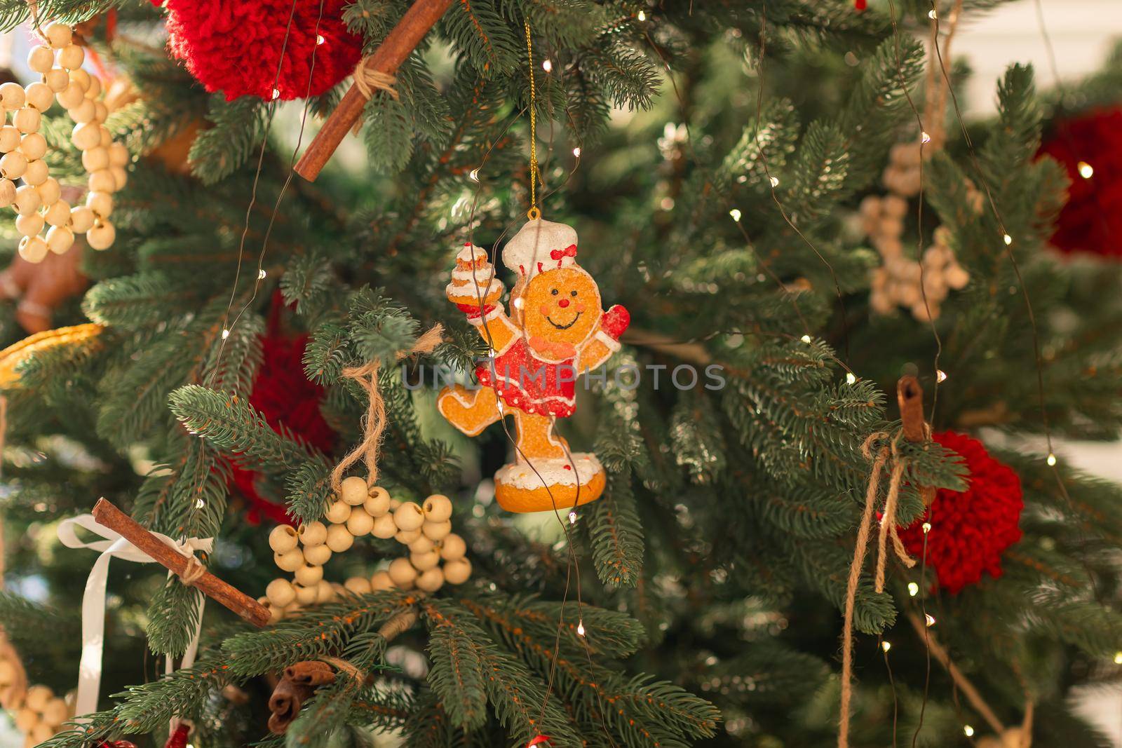 Beautiful Christmas tree decorated with gingerbread, dried oranges and cinnamon. Merry Christmas and New Year holidays background.
