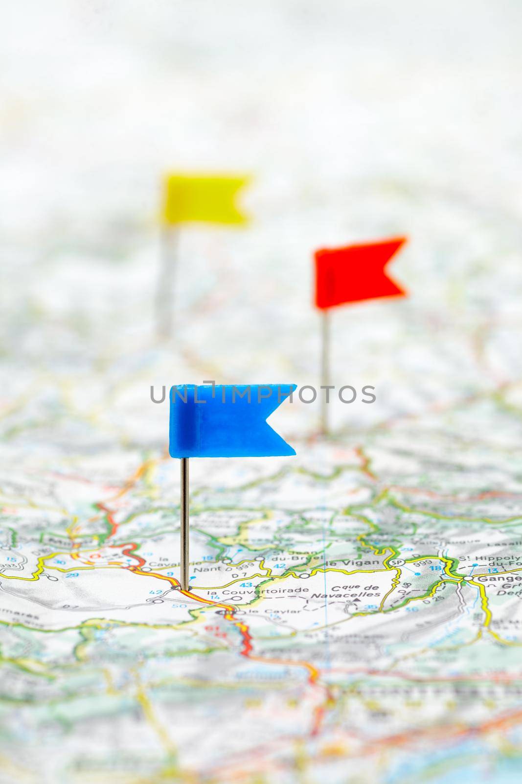 Three color flag pins on a map as travel destinations concept