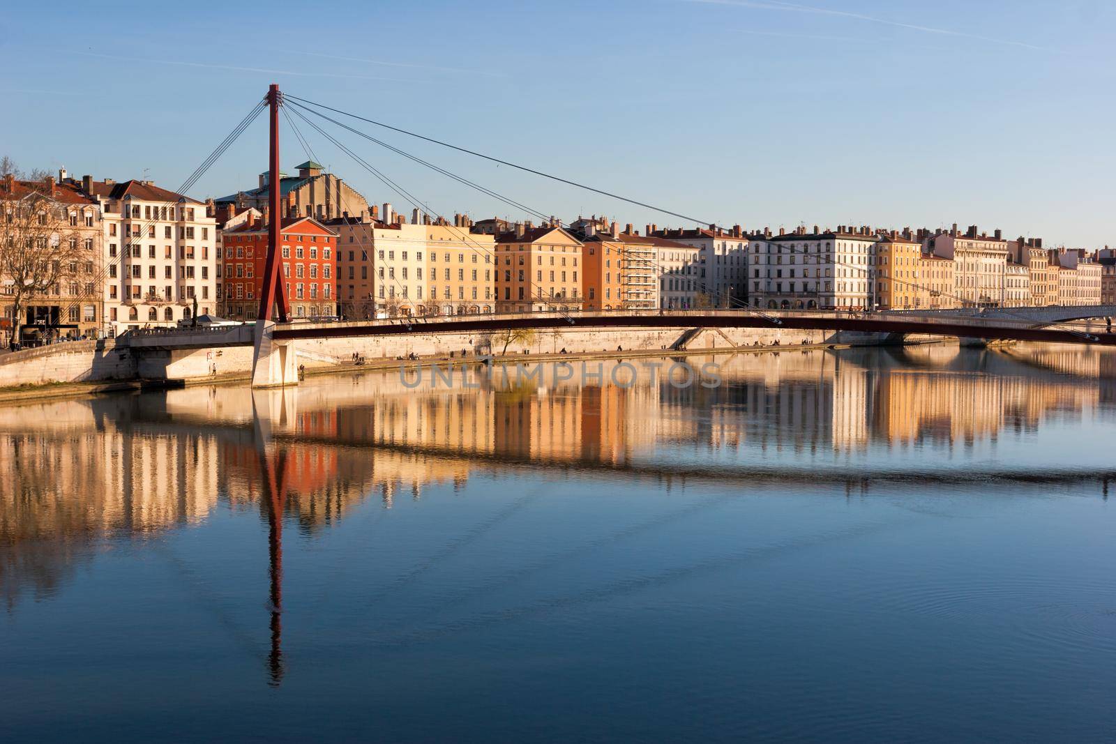 Lyon skyline with footbridge over the Saone river and waterfront buildings France Europe by naumoid