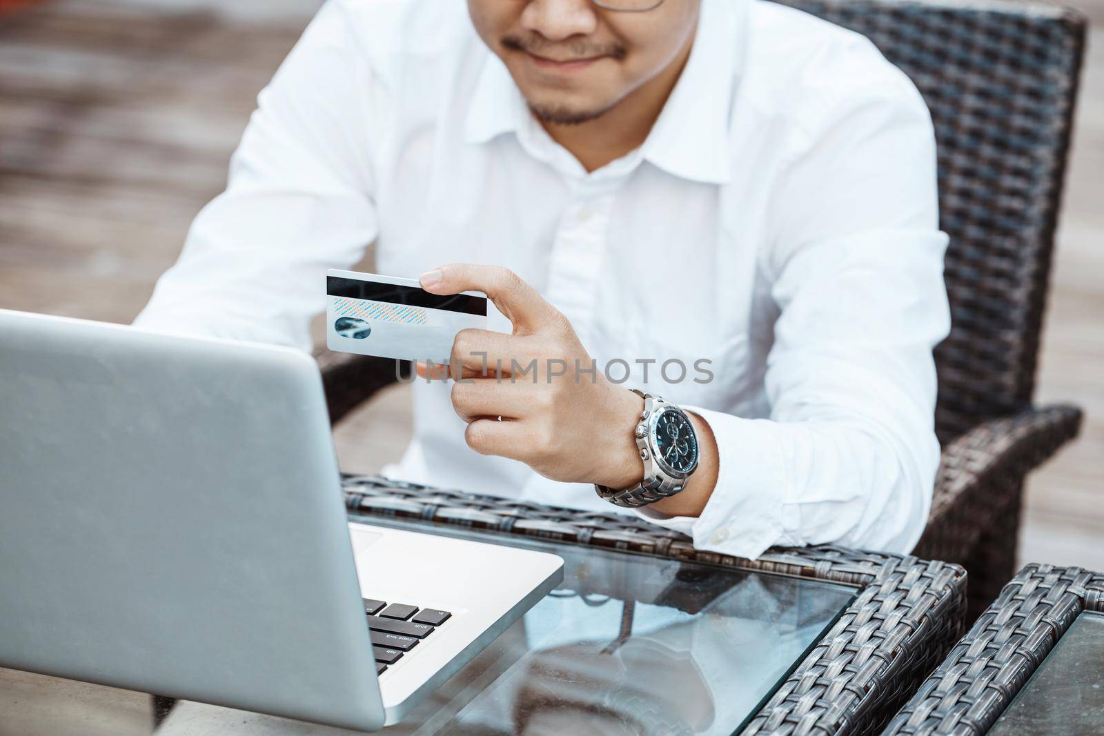 Young Handsome man enjoy shopping online on mobile phone with credit card.