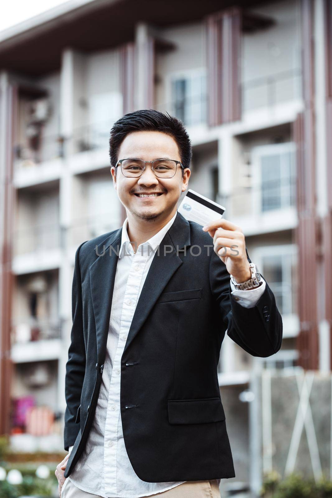 Young Handsome man enjoy shopping online on mobile phone with credit card by Benzoix