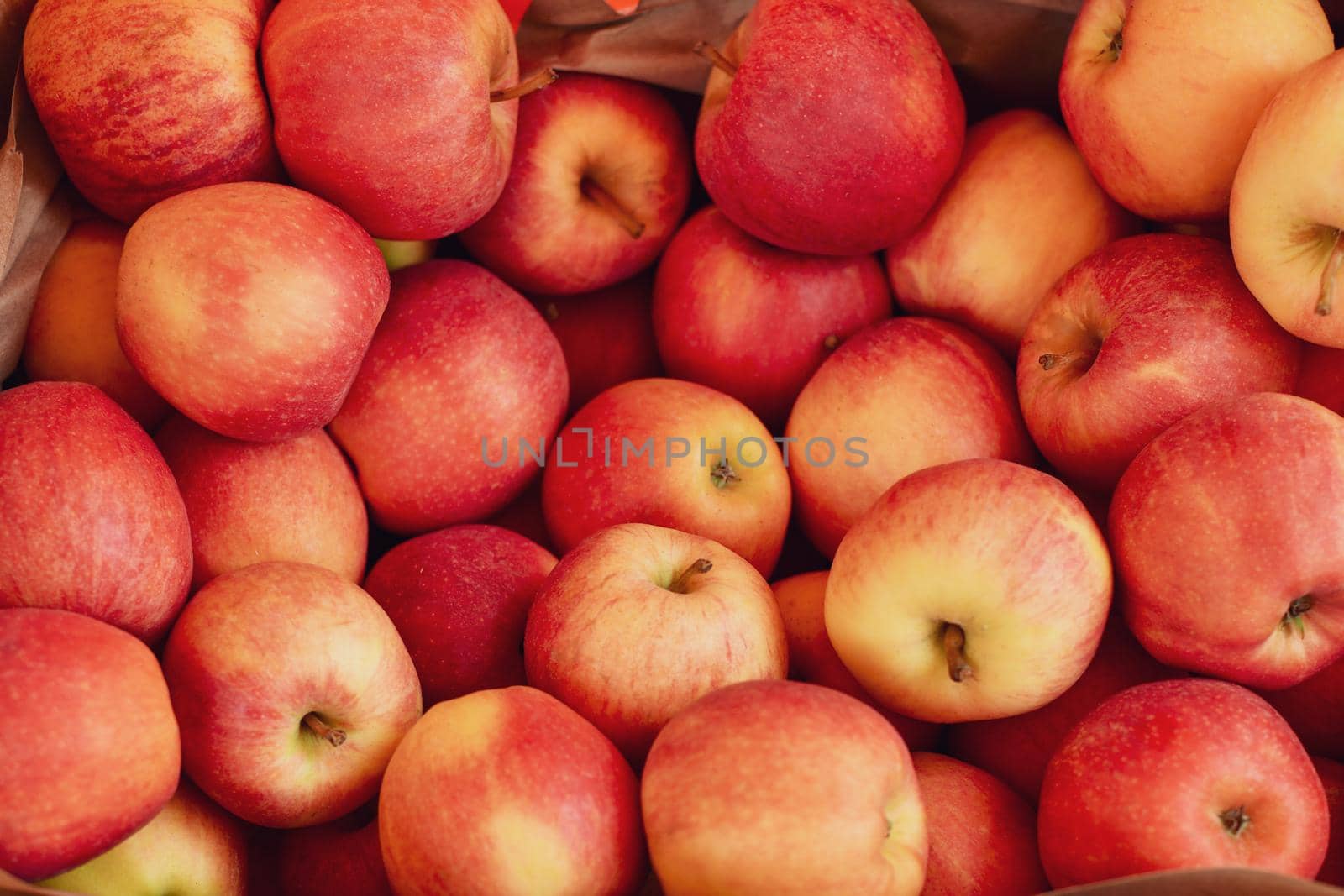 Red yellow apples in a basket at the market