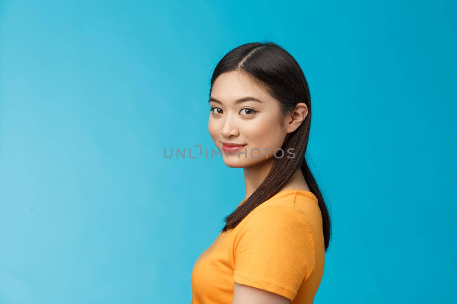 Close-up tender feminine stylish young female turn camera stand profile, look camera amused joyful, satisfied getting rid acne, taking care facial blemish, stand blue background delighted by Benzoix
