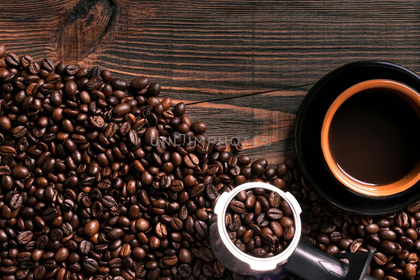 Coffee cup and coffee beans on wooden background. Top view. Still life. Copy space. Flat lay.