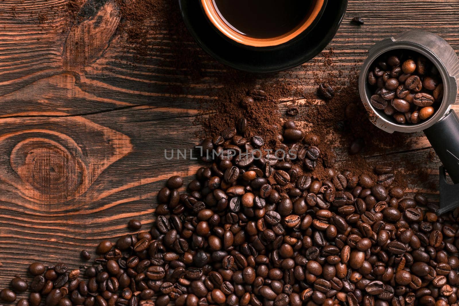 Coffee cup and beans frame on wooden table. Top view. Copy space. Still life. Mock-up. Flat lay