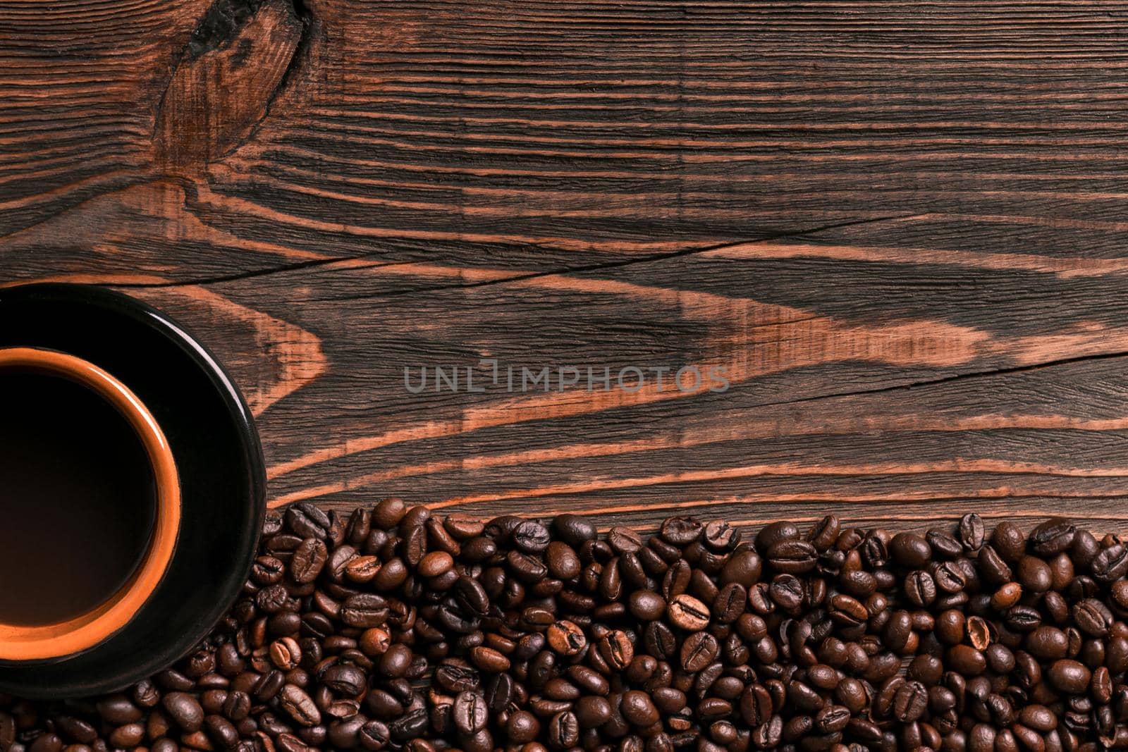 Coffee cup and beans frame on wooden table. Top view. Copy space. Still life. Mock-up. Flat lay