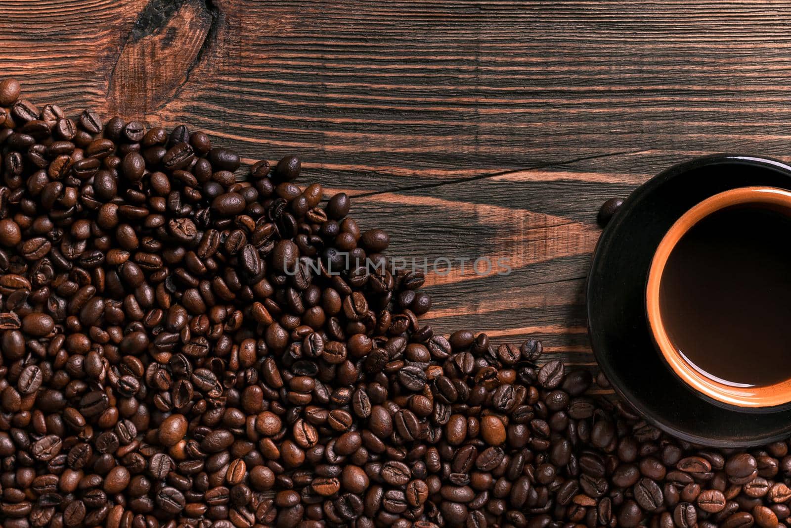 Coffee cup and beans frame on wooden table. Top view. Copy space. Still life. Mock-up. Flat lay