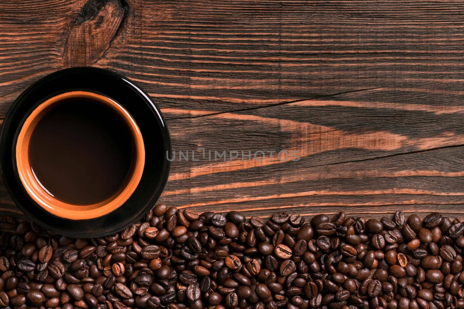 Coffee cup and beans frame on wooden table. Top view. Copy space. Still life. Mock-up. Flat lay