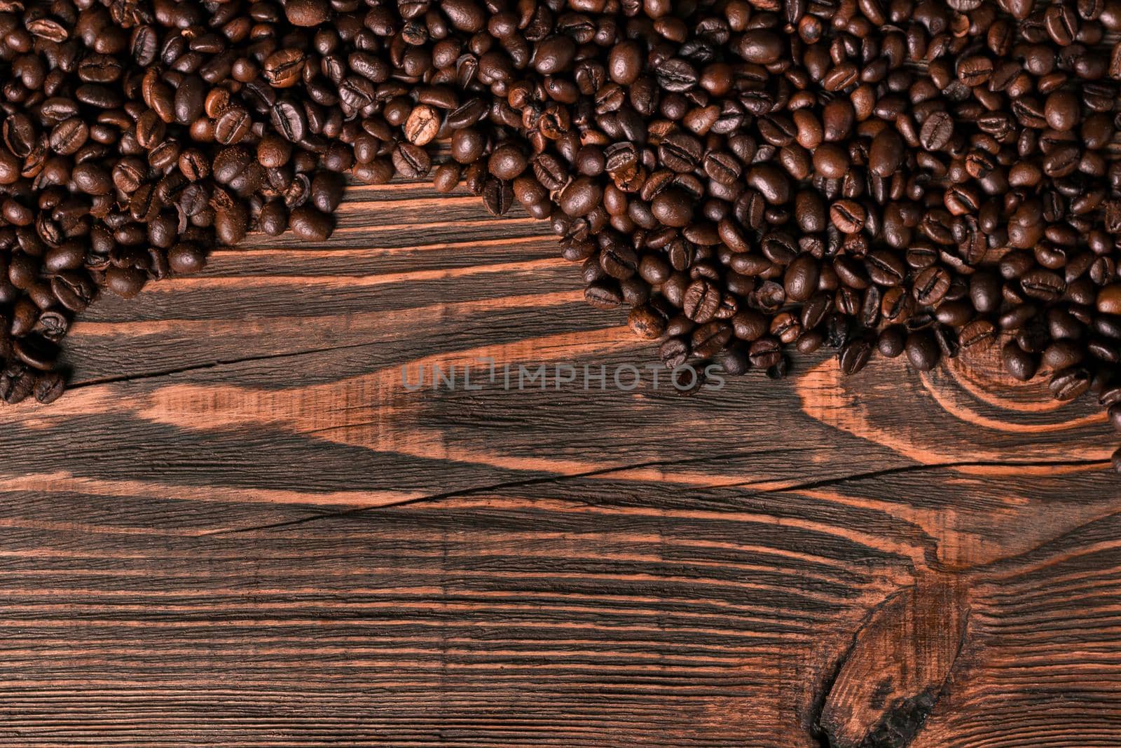 Coffee beans on wooden background. Top view. Still life. Copy space. Flat lay.