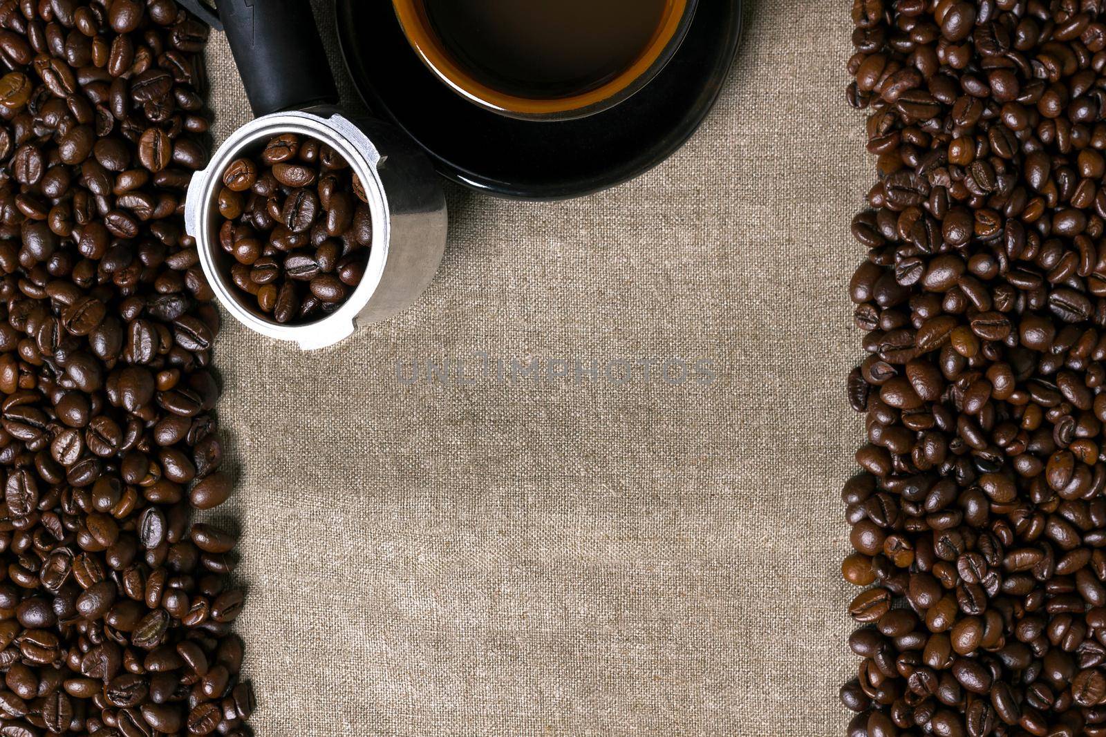 Coffee beans and Coffee cup on a burlap background. Top view. Copy space. Still life. Mock-up. Flat lay