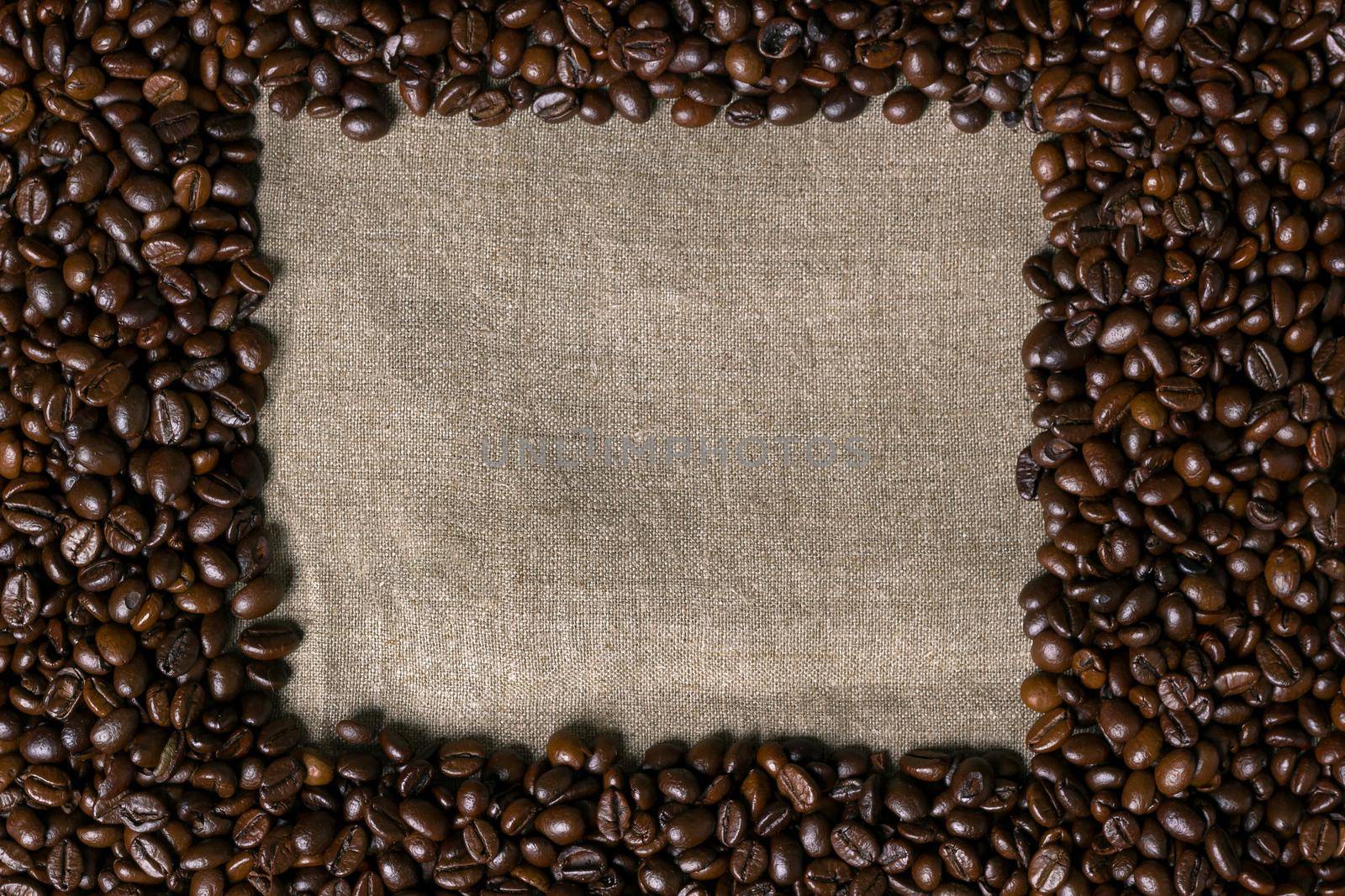 Coffee beans on burlap background. Top view. Copy space. Still life. Mock-up. Flat lay